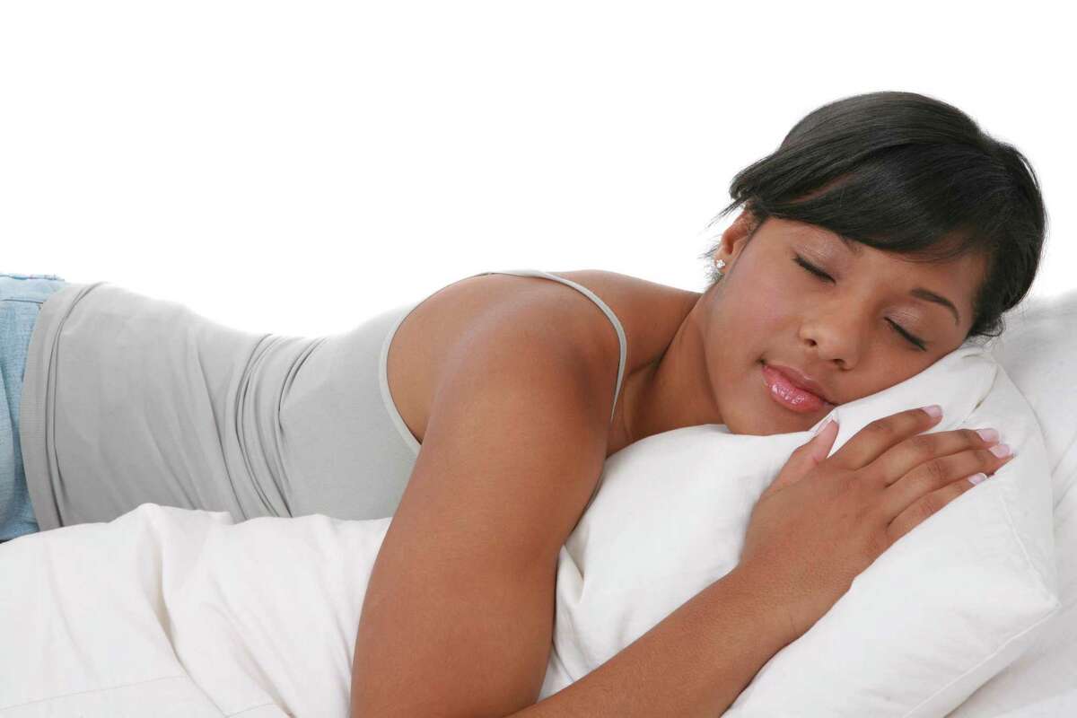 Young African American Female Taking Nap on White Background
