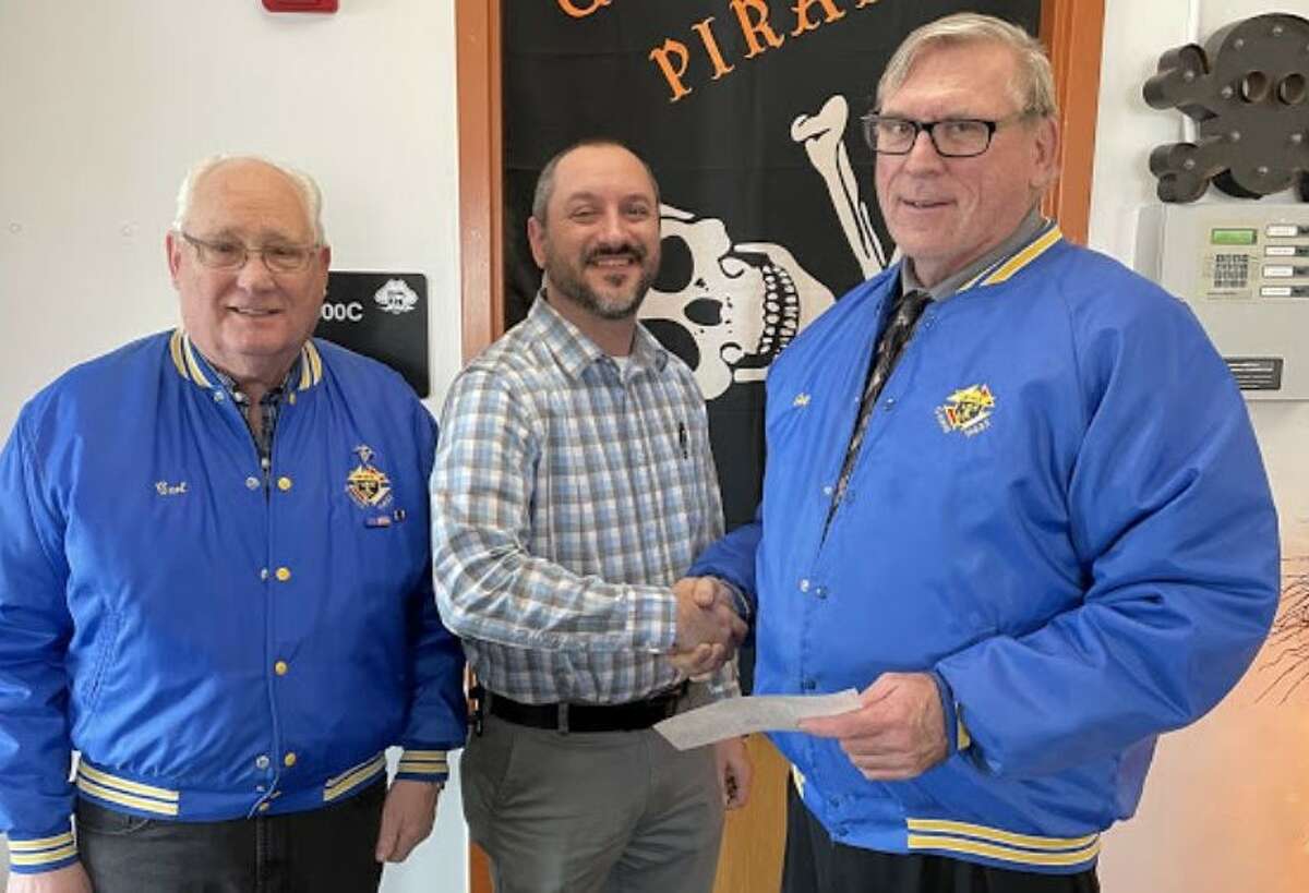 Knights of Columbus members Carl Siemen (L) and Gary Polega (R) present the donation check to HS/MS Principal Aaron Bulgrien (C).