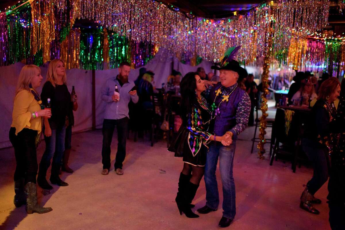 Patrick Ramsey, right, Dances with Anita Cisneros, left, at the 11th Street Cowboy Bar during the Cowboy Mardi Gras celebration in Bandera, Texas on February 15, 2020. (Photo by Mark Felix / AFP) (Photo by MARK FELIX/AFP /AFP via Getty Images)