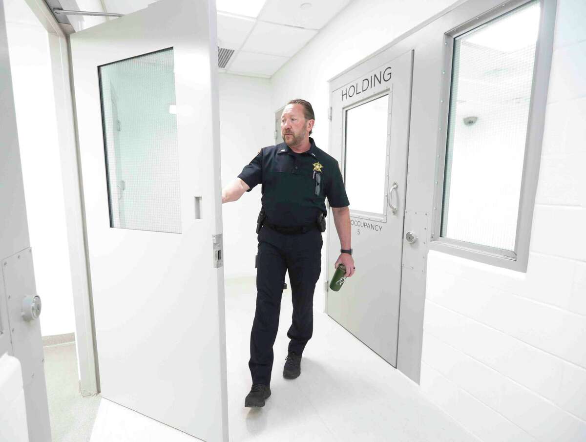 Lt. John Schmitt with the Montgomery County Sheriff’s Office shows on of the multi-person jail cells in the department’s new, $11.8 million state-of-the-art District 4 building, Thursday, April 7, 2022, in Magnolia. In addition to serving as a location for deputies’ daily work, the 16,760 square foot facility can hold up to 23 people who have been detained.
