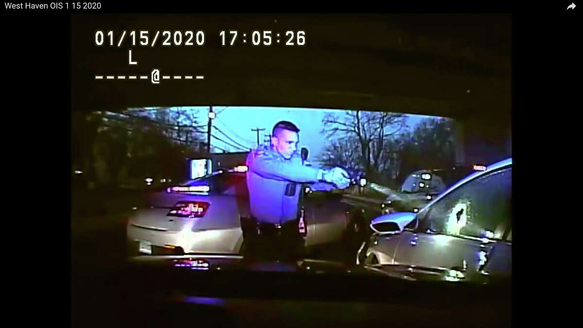This Jan. 15, 2020, still image from dashboard camera video released by the Connecticut State Police shows Trooper Brian North, left, after he discharged his weapon beside vehicle stopped in West Haven. North fatally shot Mubarak Soulemane following a high-speed chase along Interstate 95 after Soulemane, 19, had carjacked the vehicle in Norwalk.