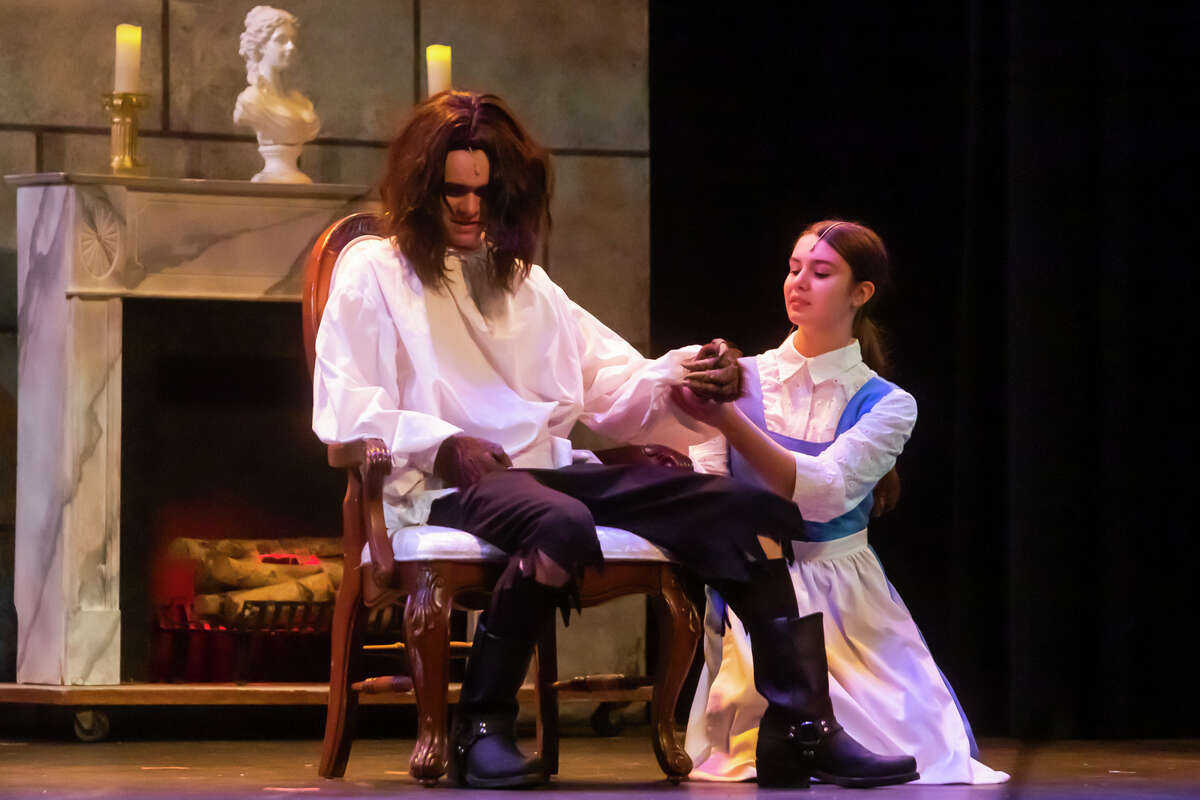 George Hageage in the role of The Beast, left, and Chloe Vandenbossche in the role of Belle, right, rehearse a scene during a dress rehearsal for Midland High School's production of "Beauty and the Beast" Wednesday, April 6, 2022 at Central Auditorium.