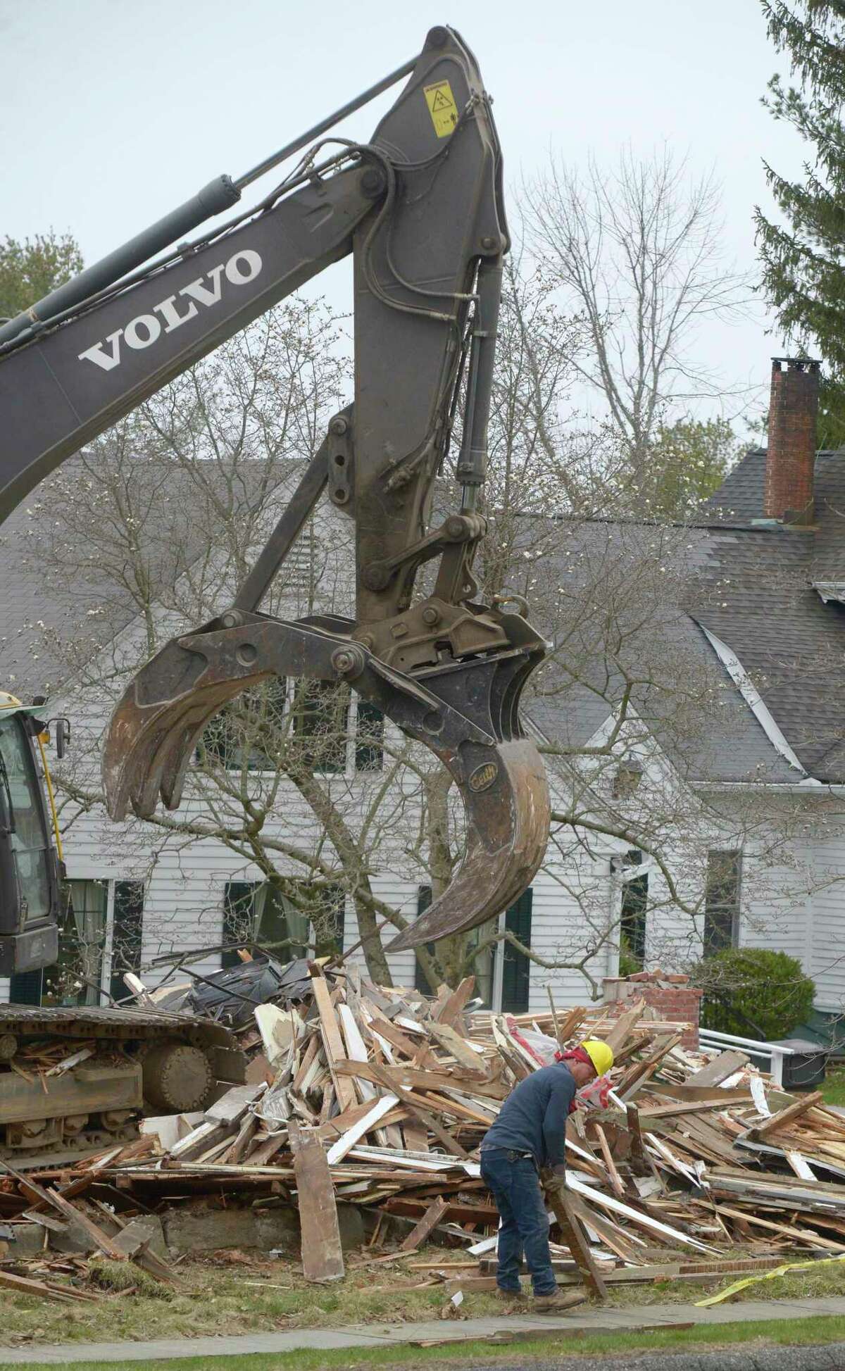 A crew from Stone Construction, of Southbury, works on the demolition of the Bridgewater Grange, Thursday, April 7, 2022, Bridgewater, Conn.
