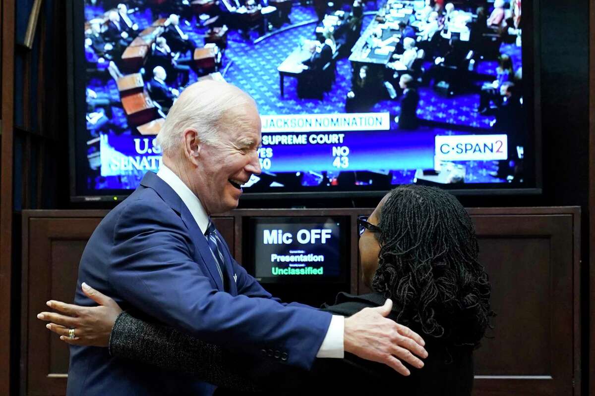 President Joe Biden goes to hug Supreme Court nominee Judge Ketanji Brown Jackson as they watch the Senate vote on her confirmation from the Roosevelt Room of the White House in Washington, Thursday, April 7, 2022. (AP Photo/Susan Walsh)