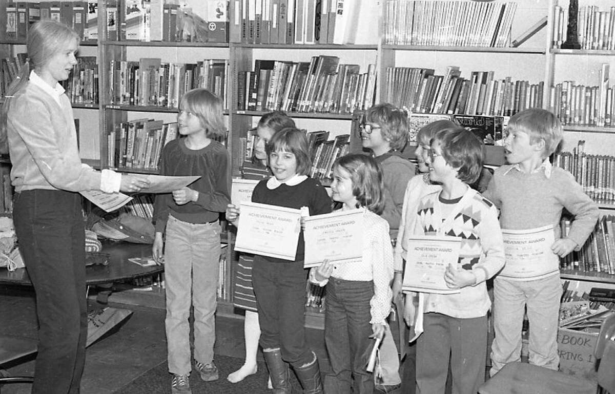 A number of Central School students received their certificates of completion in the Junior Great Books program yesterday, awarded to them by program instructor, (left) Lynda Hegg. (From left) Leslie Hayes, Amy Horvat, Melissa Mackin, Jennifer Hansen, Jason Verheek, Charles Kott, Julie Green and Joshua Hegg are pictured. The photo was published in the News Advocate on April 8, 1982.