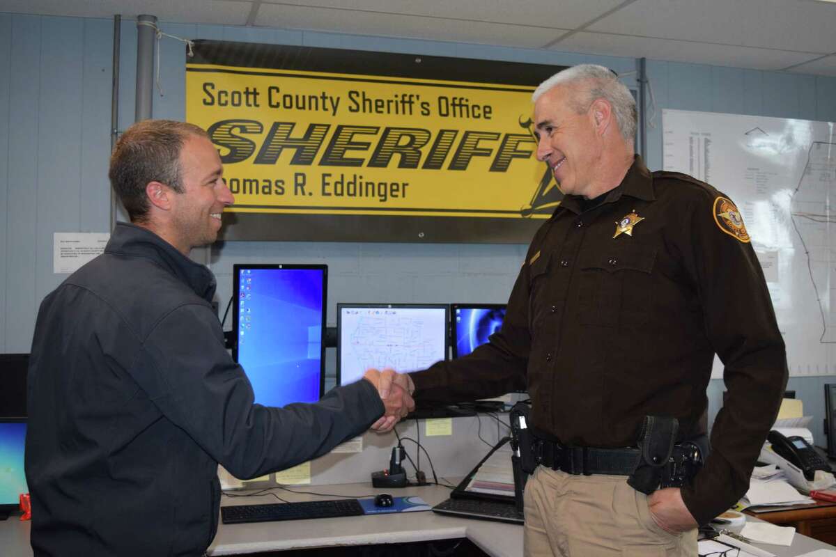 Scott County Sheriff Tom Eddinger (right) thanks Alex Sammet, Spire's manager of right of way and land management, for a $5,000 donation.