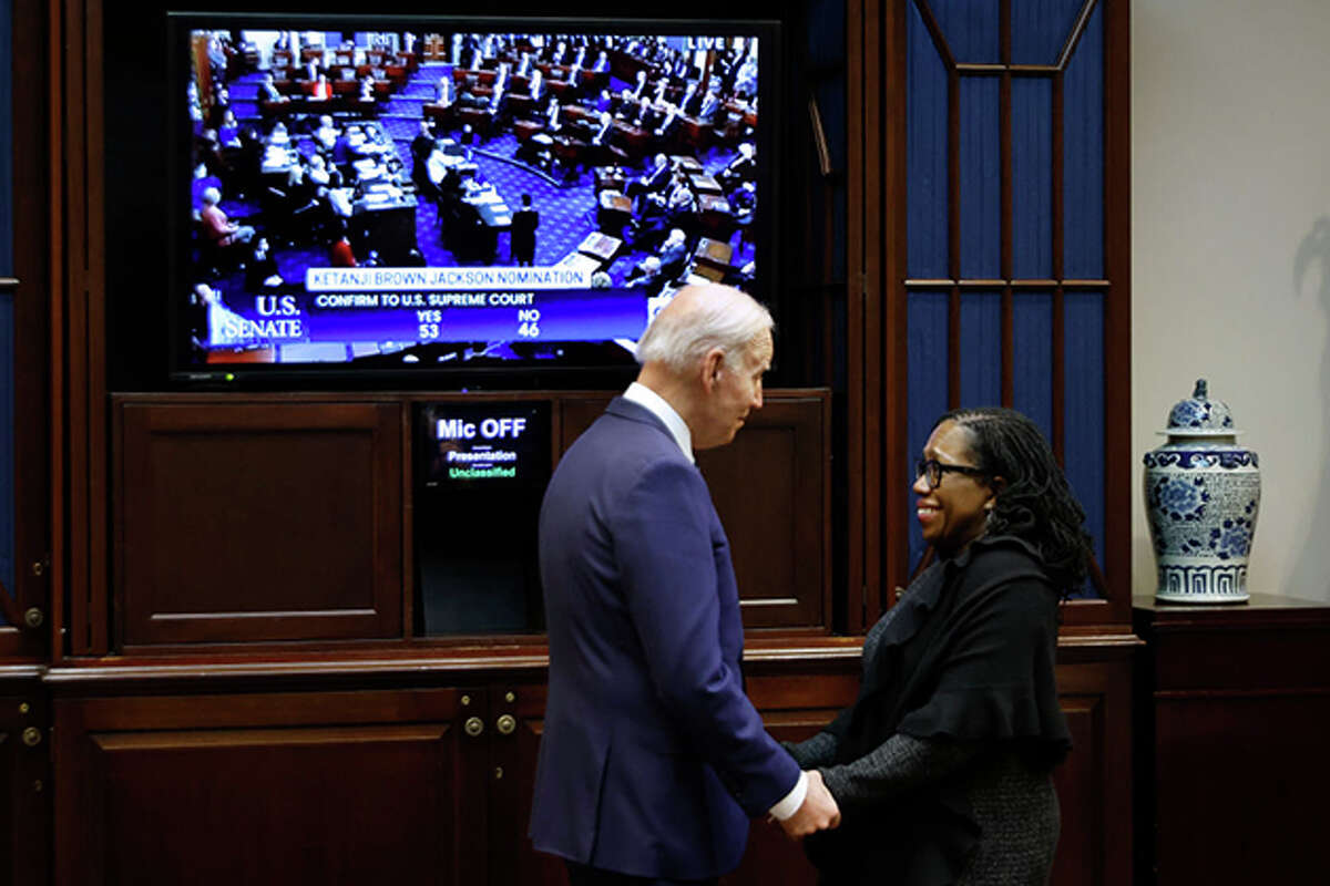 President Joe Biden congratulates Ketanji Brown Jackson on Thursday at the White House, moments after the U.S. Senate confirmed her as the first Black woman justice on the Supreme Court.