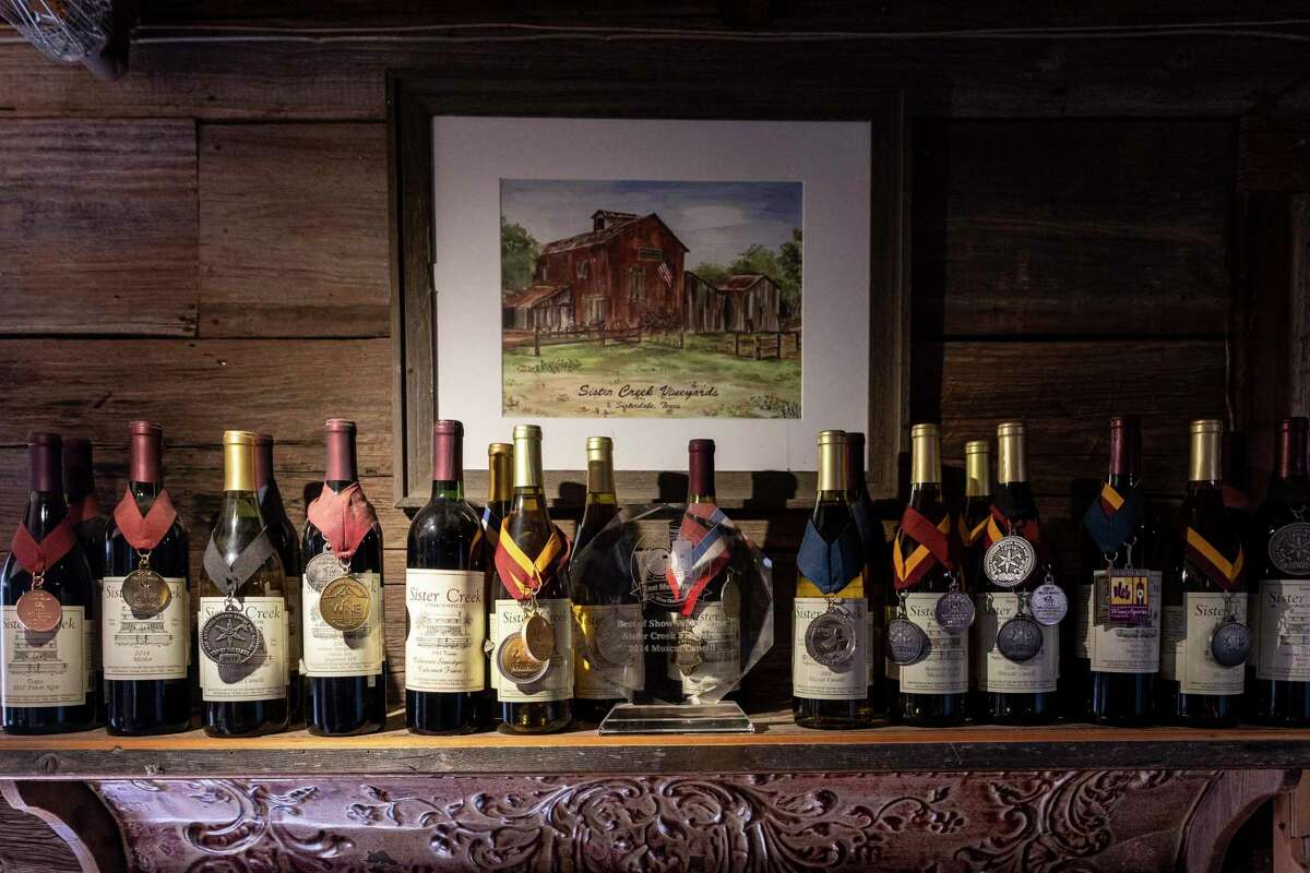 Award-winning bottles of wine line the shelves inside the tasting room at Sister Creek Vineyards in Sisterdale.