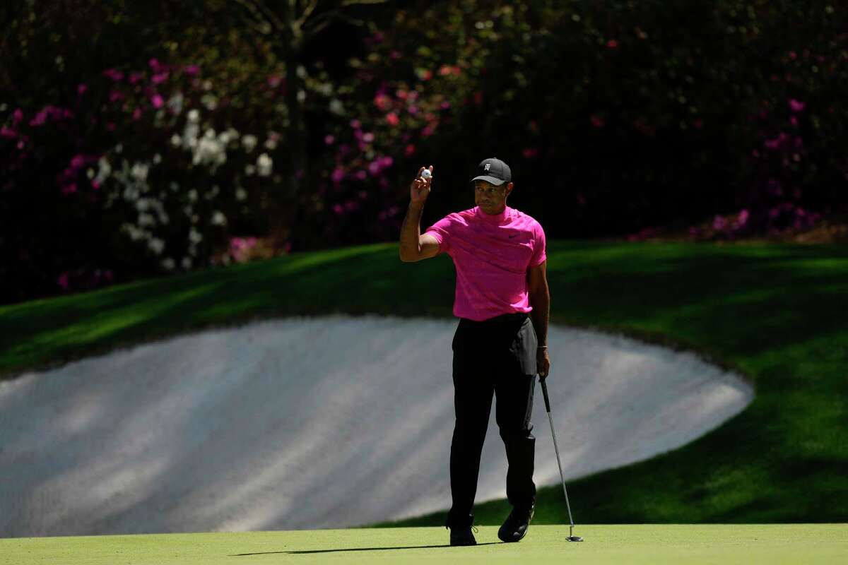 Tiger Woods holds up his ball after a birdie on the 13th hole during the first round at the Masters golf tournament on Thursday, April 7, 2022, in Augusta, Ga.