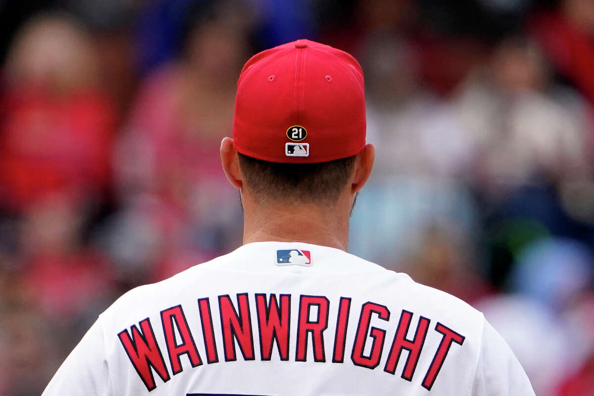 St. Louis Cardinals starting pitcher Adam Wainwright pauses between batters while wearing No. 21 on his cap during the fourth inning Thursday, April 7, 2022, in St. Louis. Winners of the Roberto Clemente Award, like Wainwright, will wear his No. 21 on back of their caps for the rest of their major league careers.