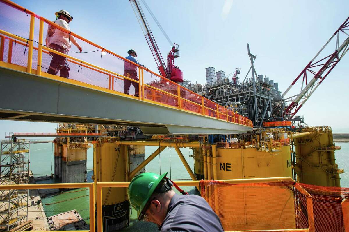 Workers make their way across the gangplank as they board Shell’s Vito platform during construction of the project Wednesday, April 6, 2022 in Ingleside.