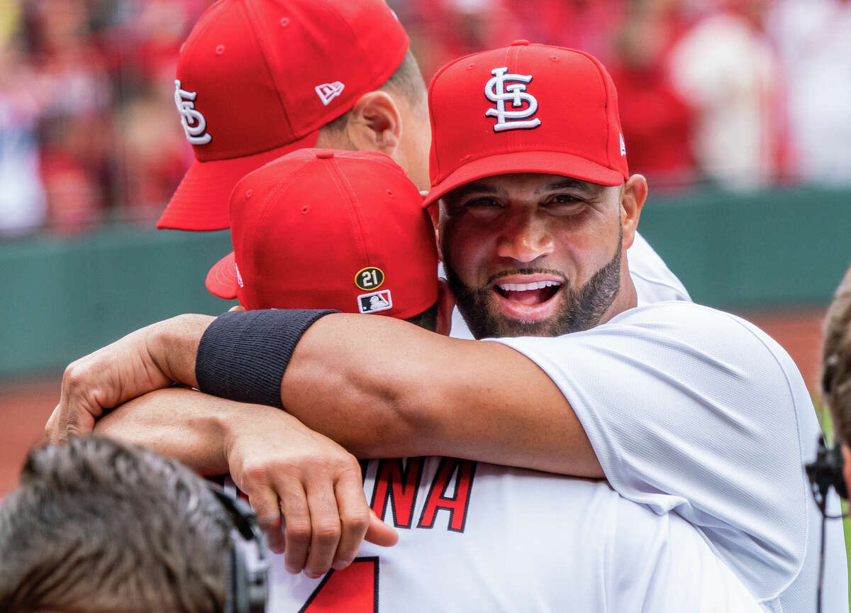 The Cardinals'  Albert Pujols embraces catcher and close friend Yadier Molina before Thursday's Opening Day game against the Pittsburgh Pirates. 