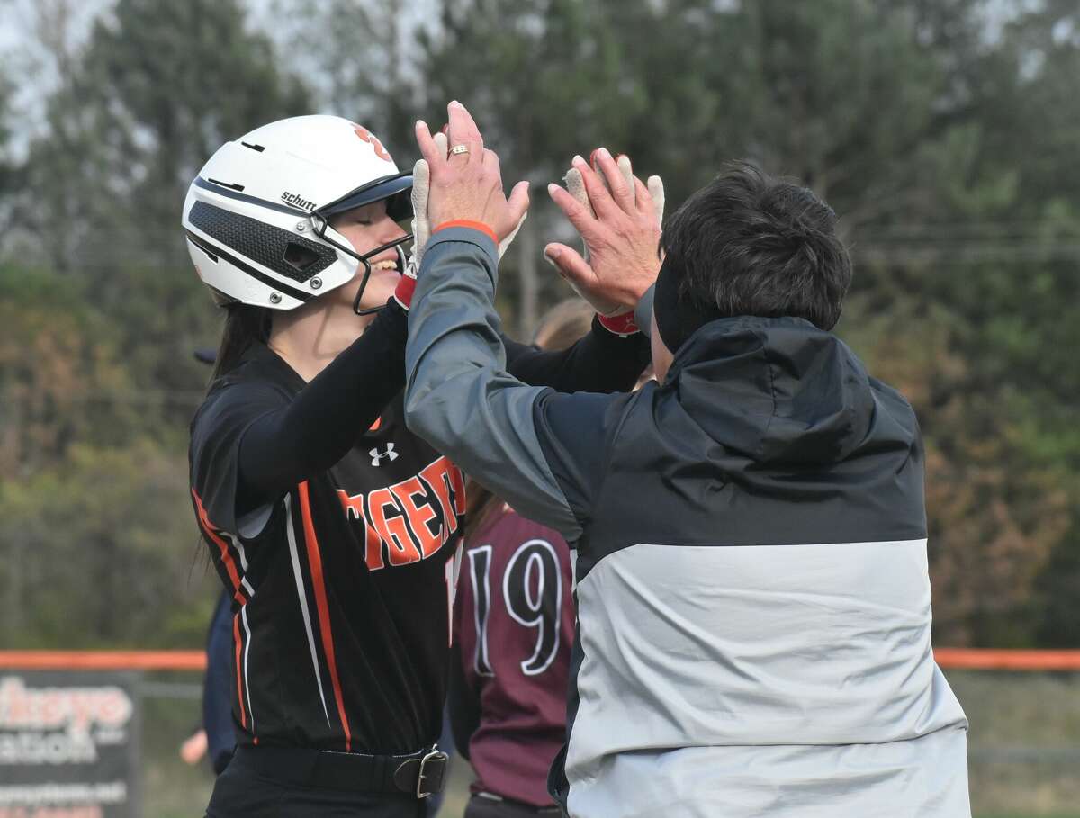 Edwardsville's Tatum VanRyswyk is congratulated by coach Lori Blade after a triple with one out in the sixth against Belleville West during Thursday's game inside the District 7 Sports Complex.