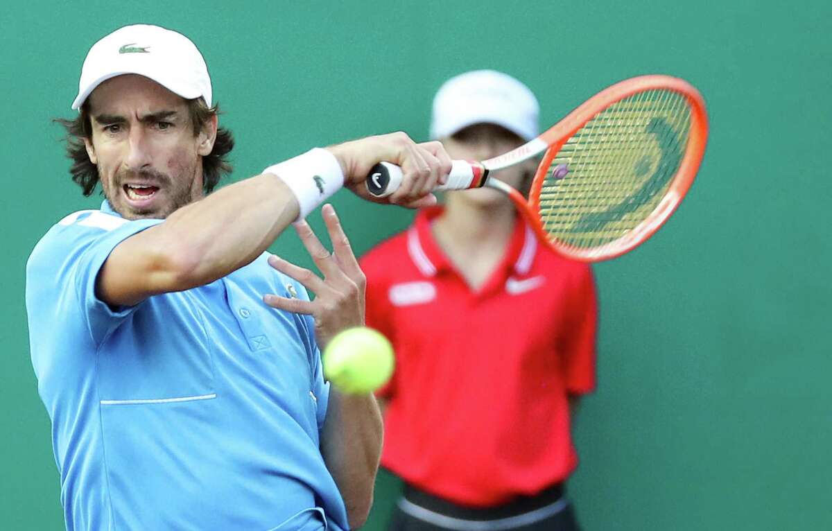 Pablo Cuevas, URU, returns a serve to France Tiafoe, USA, during the second round of the Fayez Sarofim & Co. U.S. Men’s Clay Court Championship at River Oaks Country Club in Houston on Thursday, April 7, 2022. Tiafoe won in a 3rd set tie breaker.