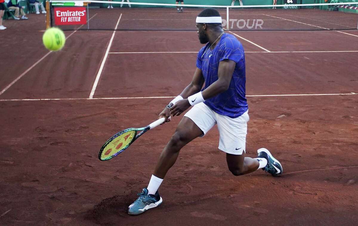 France Tiafoe, USA, misses a serve by Pablo Cuevas, URU, in the second round of the Fayez Sarofim & Co. U.S. Men’s Clay Court Championship at River Oaks Country Club in Houston on Thursday, April 7, 2022. Tiafoe won in a 3rd set tie breaker.