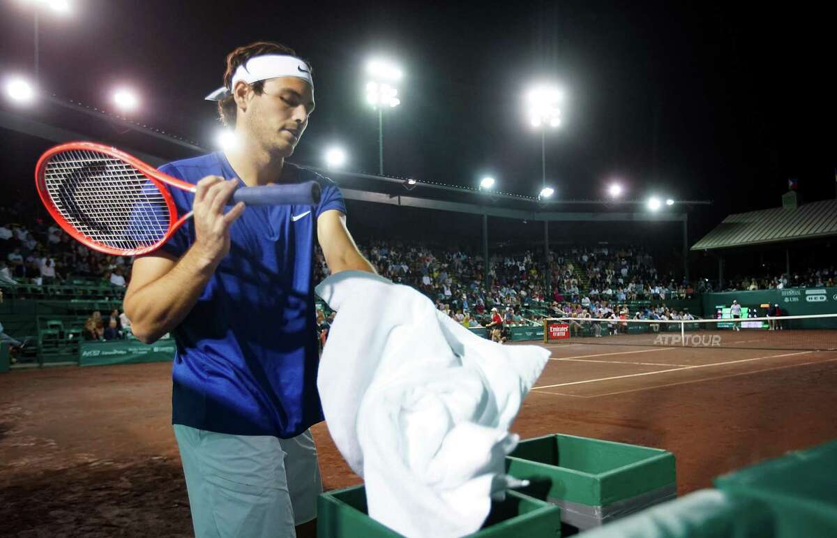 Taylor Fritz, USA, dries off his racket during while playing against Alejandro Tabilo, CHI, during the second round of the Fayez Sarofim & Co. U.S. Men’s Clay Court Championship at River Oaks Country Club in Houston on Thursday, April 7, 2022. Fritz won the match 6-1, 6-4.