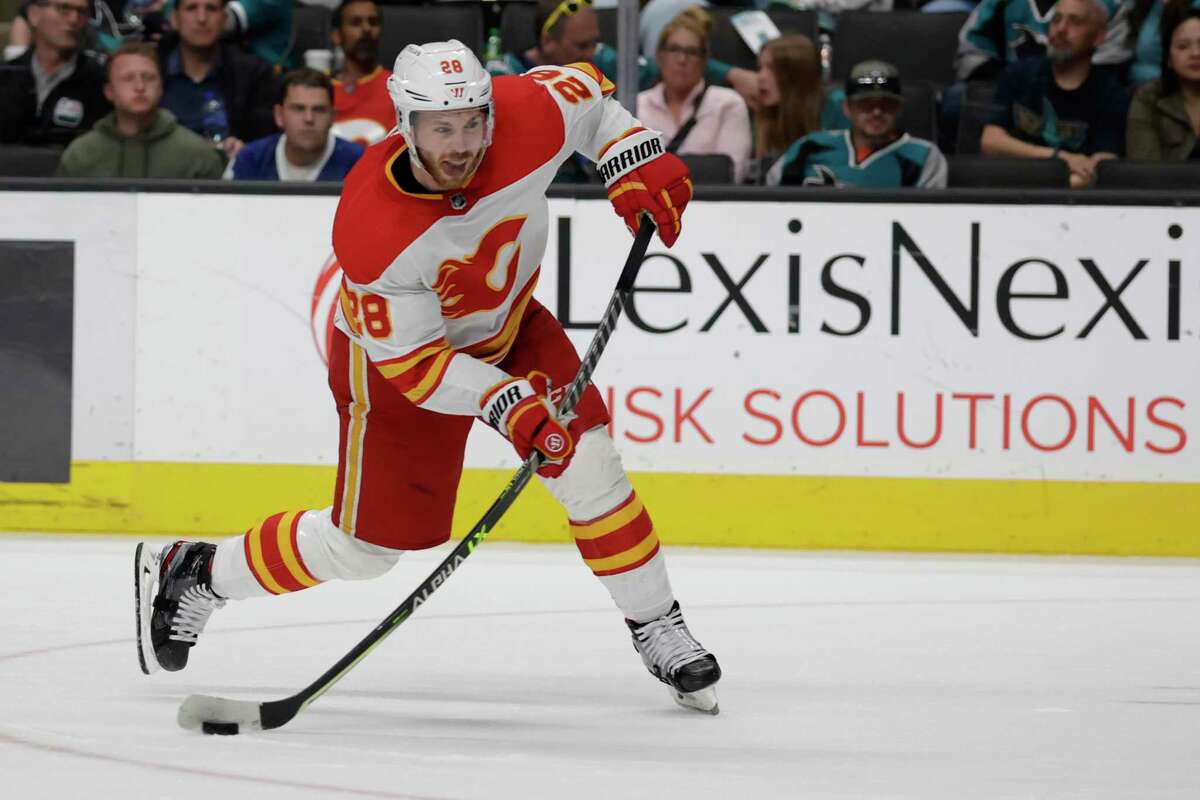 Calgary Flames center Elias Lindholm scores one of his two goals in Thursday’s 4-2 defeat of the Sharks.