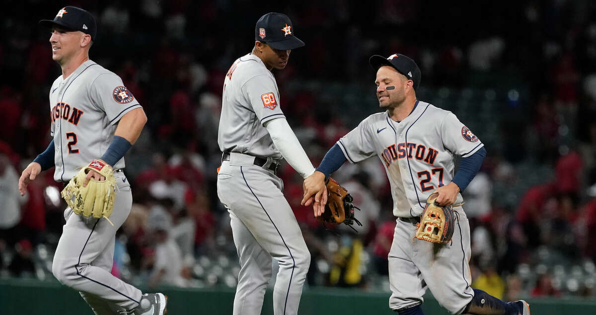 Houston Astros second baseman Jose Altuve (27) hugs shortstop Jeremy Pena (3) after the Astros won against Los Angeles Angels 3-1 during opening day at Angel Stadium on Thursday, April 7, 2022 in Anaheim.