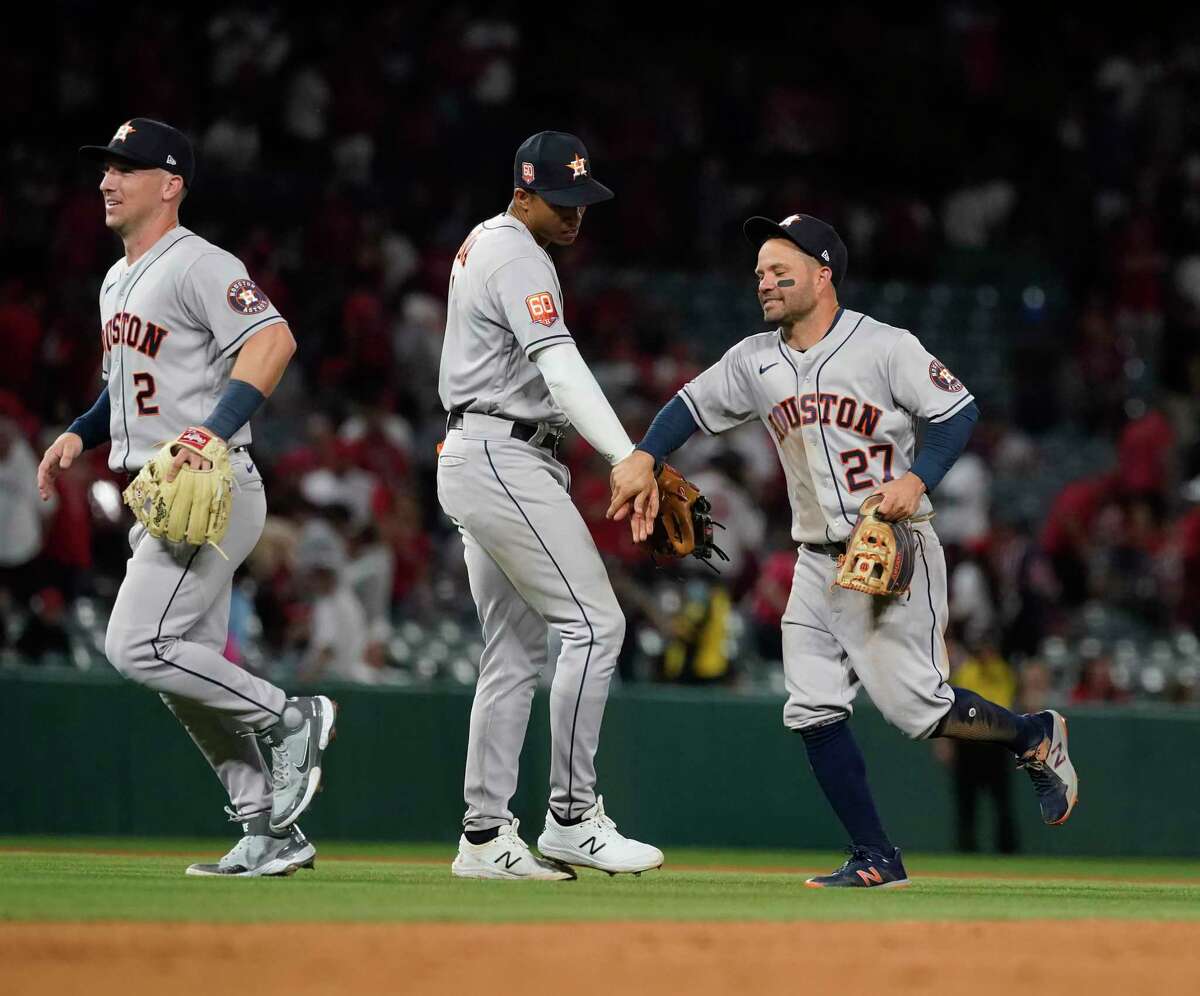 Houston Astros second baseman Jose Altuve (27) hugs shortstop Jeremy Pena (3) after the Astros won against Los Angeles Angels 3-1 during opening day at Angel Stadium on Thursday, April 7, 2022 in Anaheim.