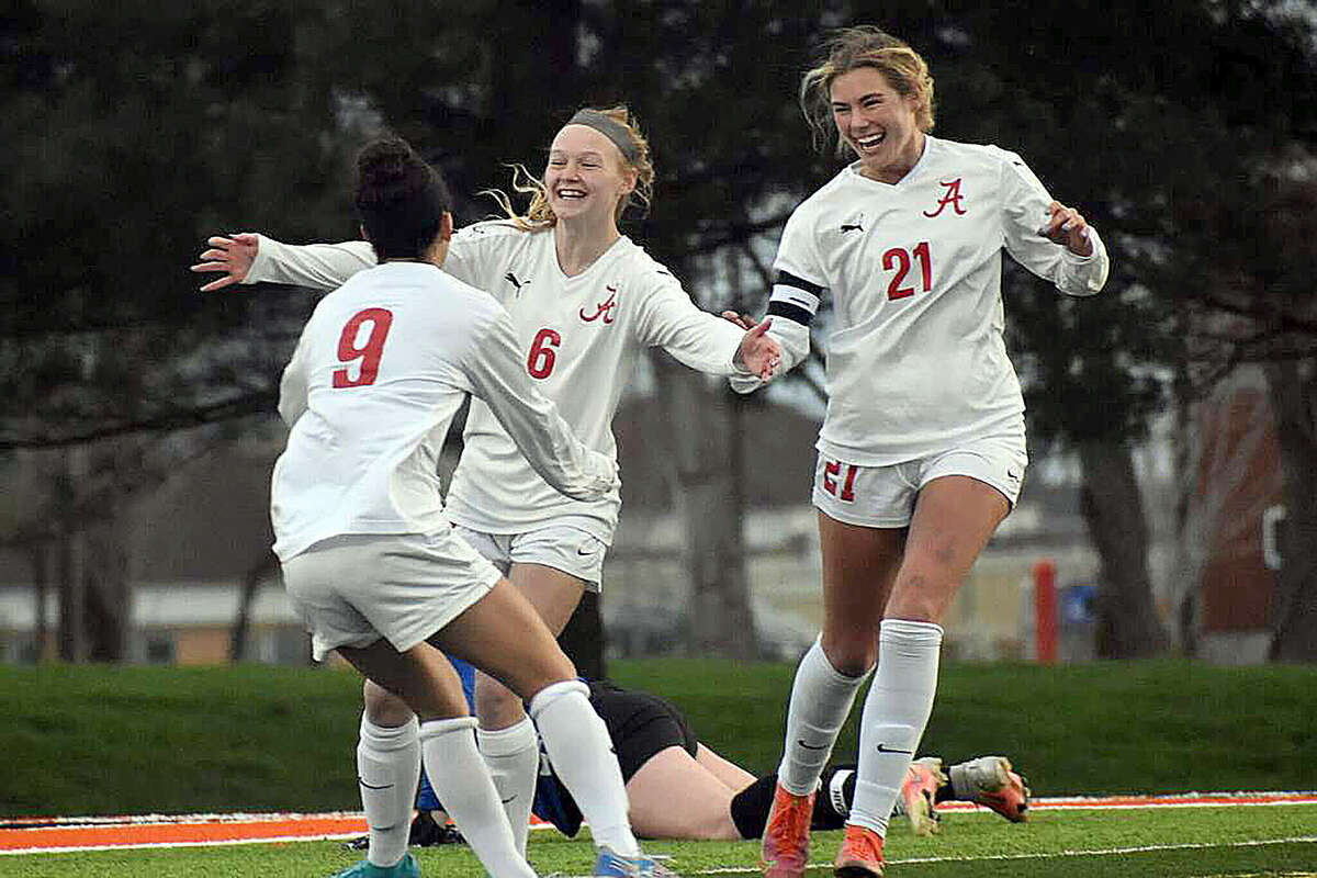 Alton's Lydsey Miller, center, is congratulated by Emily Baker, left, and Tori Schrimpf after scoring in the fourth minute of Thursday's Southwestern Conference game in Edwardsville.