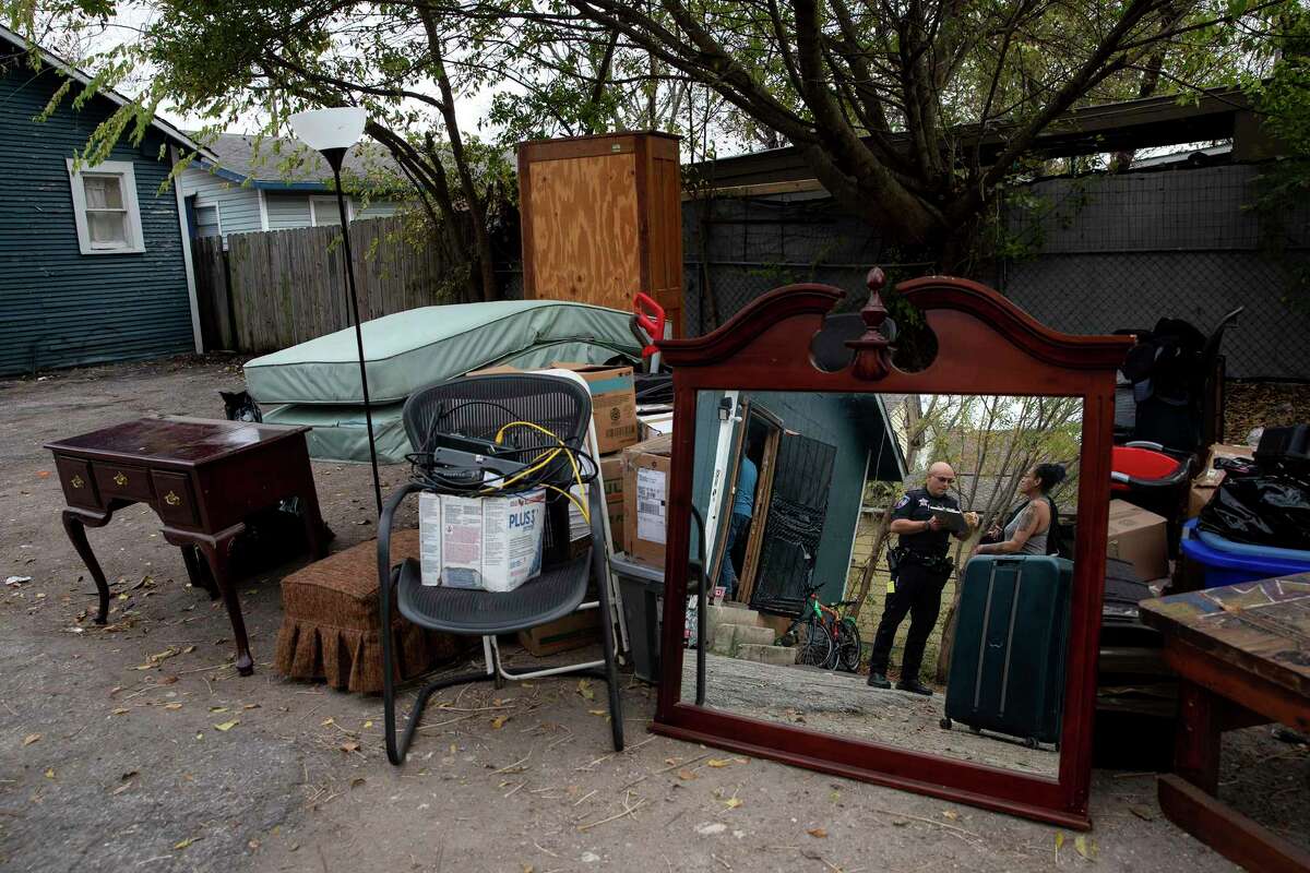 Cecilia “Hazel” Perez talks with a constable as her belongings are removed from her house on eviction day. Her story is a sorrowful reflection of the affordable housing crisis our community faces.