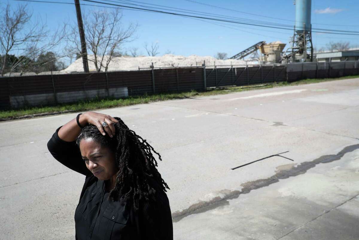 Erica Hubbard, president of the Progressive Fifth Ward Community Association, talks about health problems associated with living near concrete batch plants as she stands outside of a TexCon Ready Mix concrete batch plant in Fifth Ward on Tuesday, March 22, 2022, in Houston.
