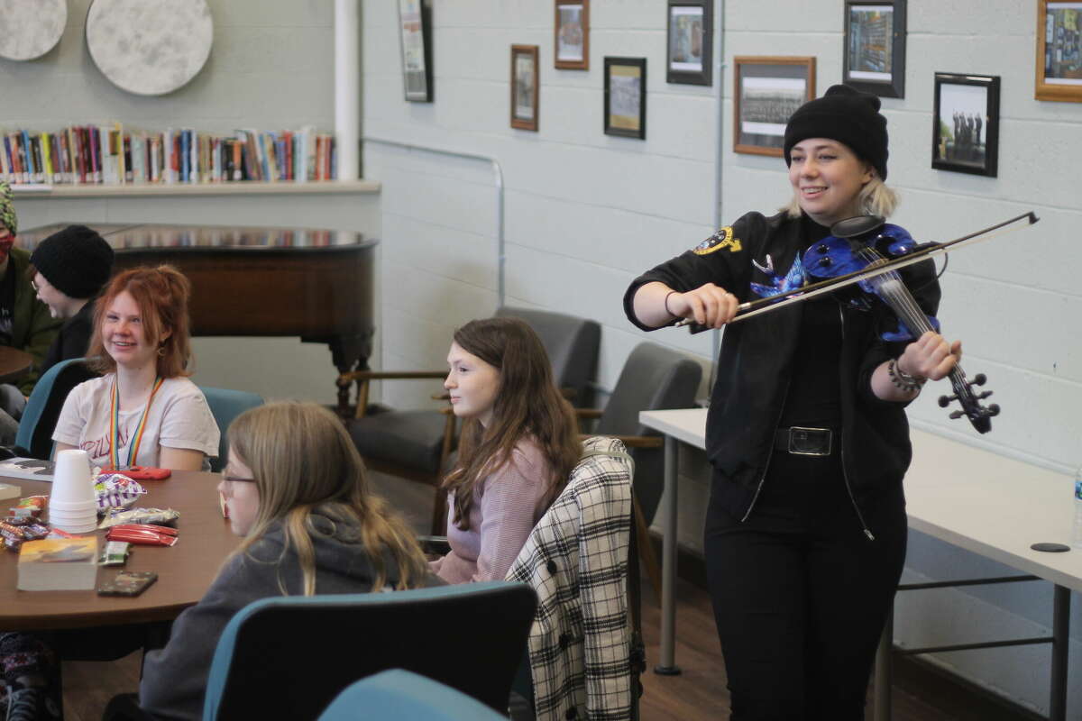 Sav Buist, of the band The Accidentals, performs for students Thursday during a songwriting workshop at the Armory Youth Project in Manistee.