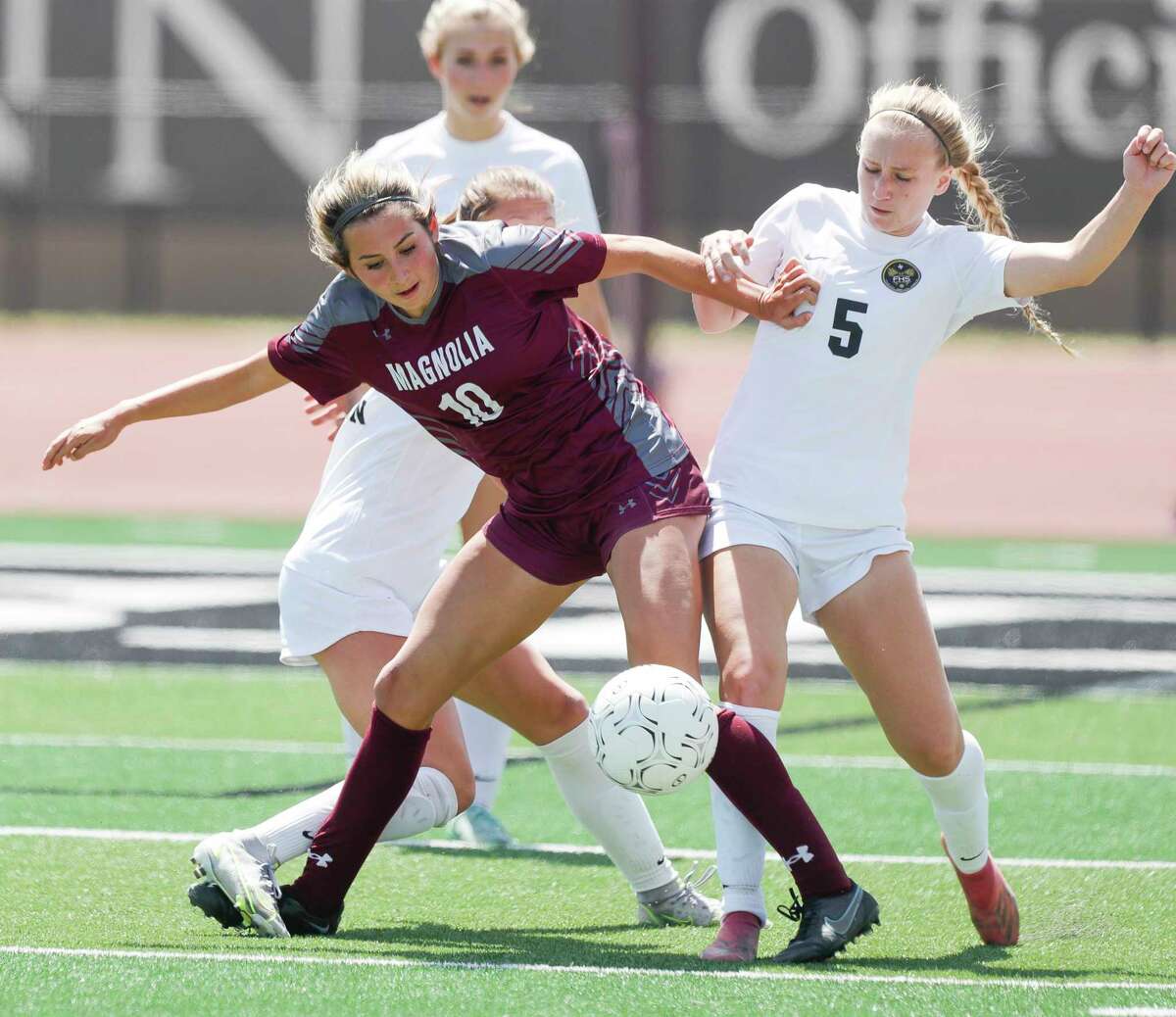 Magnolia’s Laney Gonzales (10) battles for position against Foster's Ashley Bell (5) in the second half of a Region III-5A semifinal high school soccer match at Turner Stadium, Friday, April 8, 2022, in Humble.