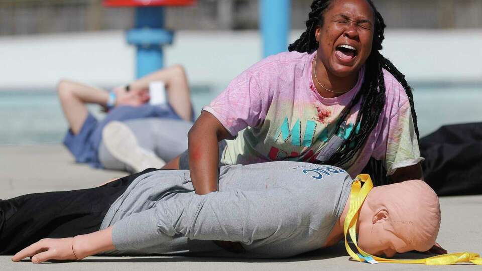 A woman screams as Montgomery County first responders respond to a simulated explosion at Big Rivers Waterpark & Adventures, Friday, April 8, 2022, in New Caney. Thirteen different agencies from around Montgomery County and surrounding areas took part in the mock event where 100 people were treated for burns and other injuries after a chemical explosion in the theme park's pool pump room.