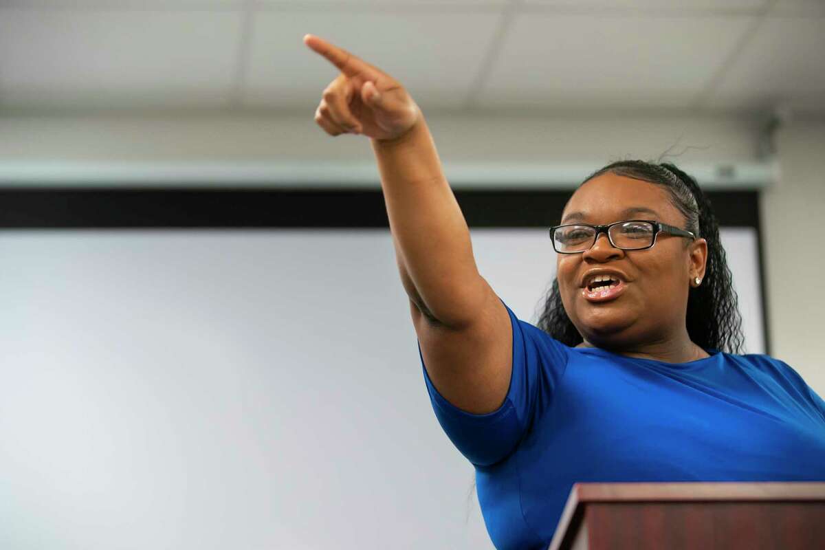 Program graduate Brigette Williams jokingly points at Wayne Salter, the HHS deputy executive commission of access and eligibility services, saying she will have his job one day during a graduation ceremony celebrating five former foster youth completing a work training program, Friday, April 8, 2022, at The HAY Center in Houston. After completing a seven-week program, the participants will now start their full-time jobs as a Texas Works Advisor with the state Health and Human Services Commission.