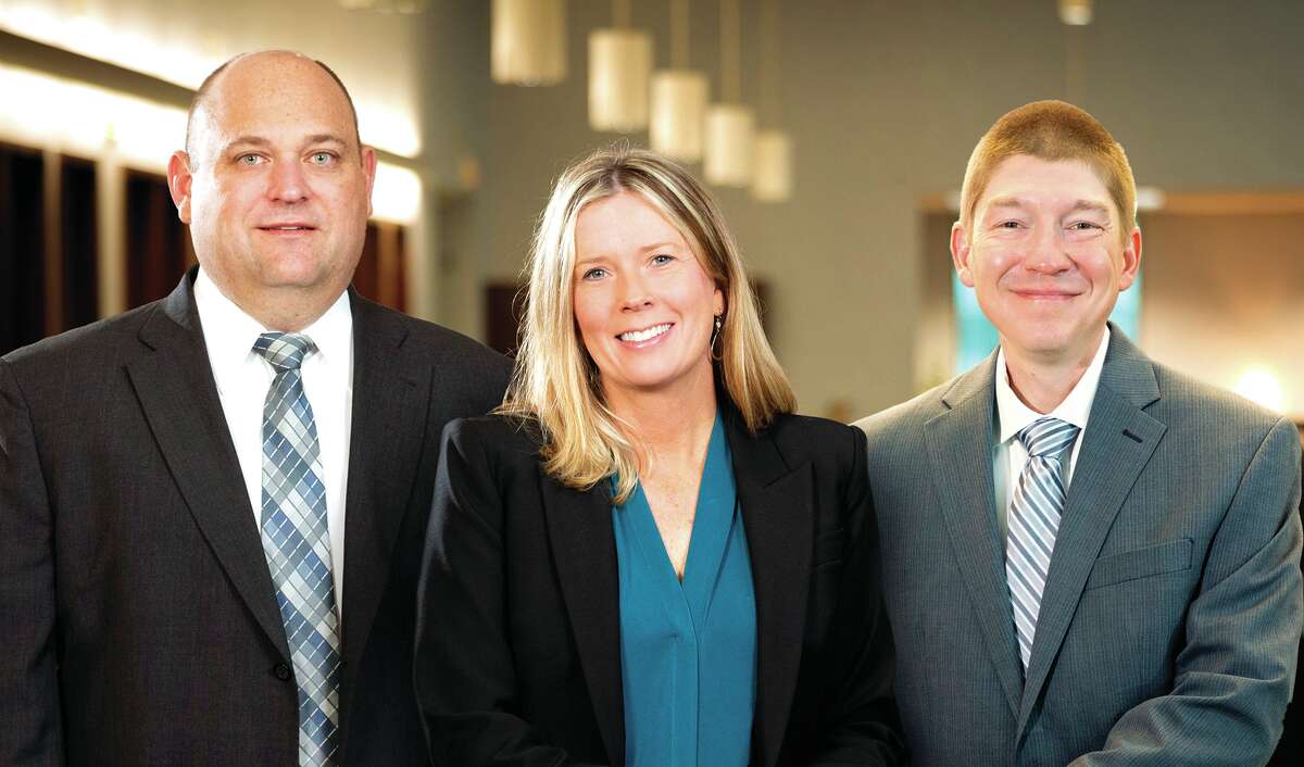 Kyle Schumacher (from left) has been named to the board of directors for CNB Bank & Trust and Jodee Nell has been named Jacksonville and Chapin market president and Matt Cors has been named vice president and senior consumer loan operations officer.