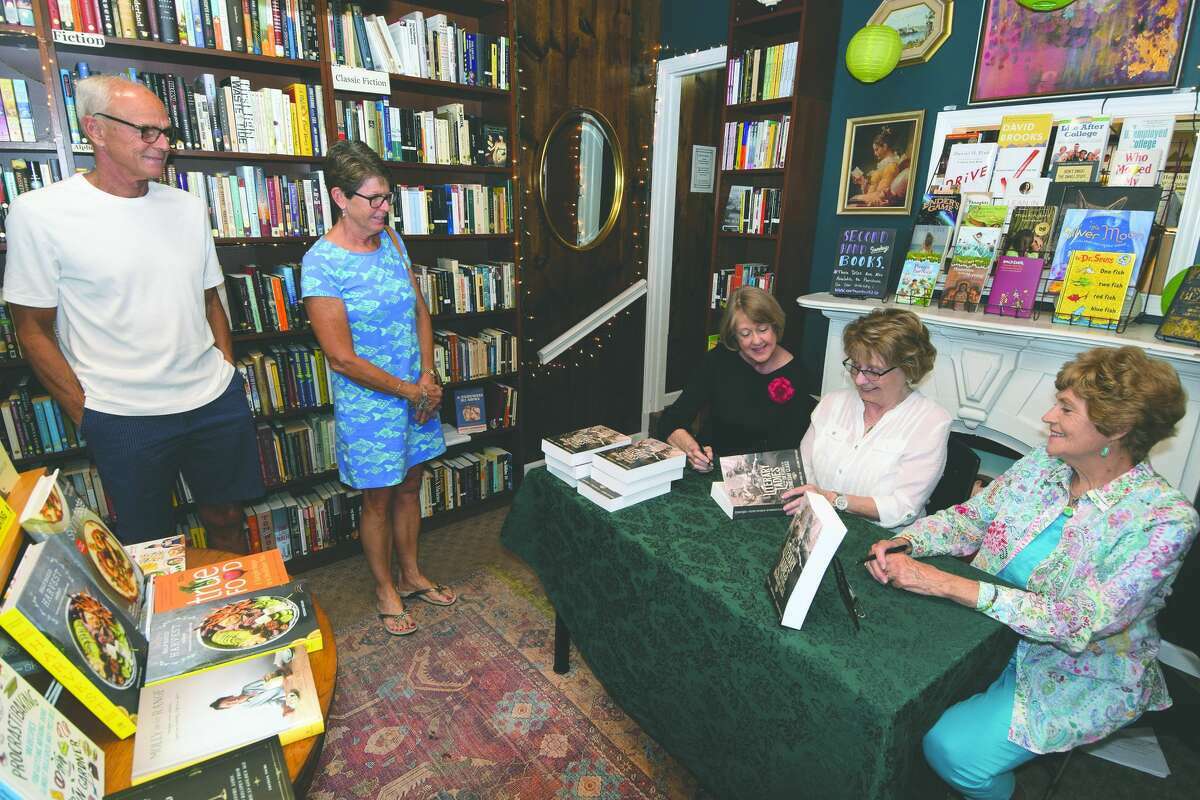 Suzanne Verticchio (seated, from left), Linda Ryan and Cathy Green — the authors of “Literary Ladies: The First 130 Years of The Wednesday Class” — sign copies of their book in June at Our Town Books.