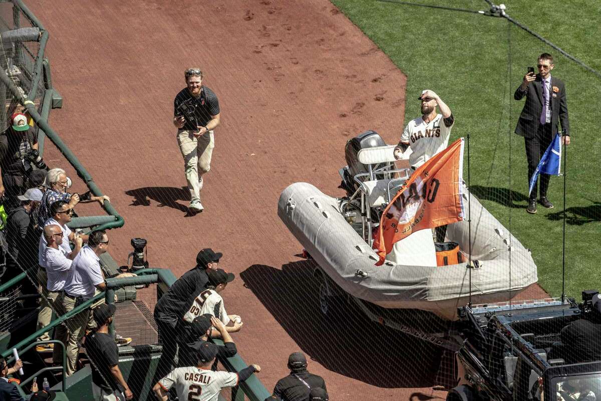 San Francisco Giants’ Brandon Belt makes his entrance on a boat to throw out the ceremonial first pitch during Opening Day against the Miami Marlins in San Francisco, Calif. Friday, April 8, 2022.