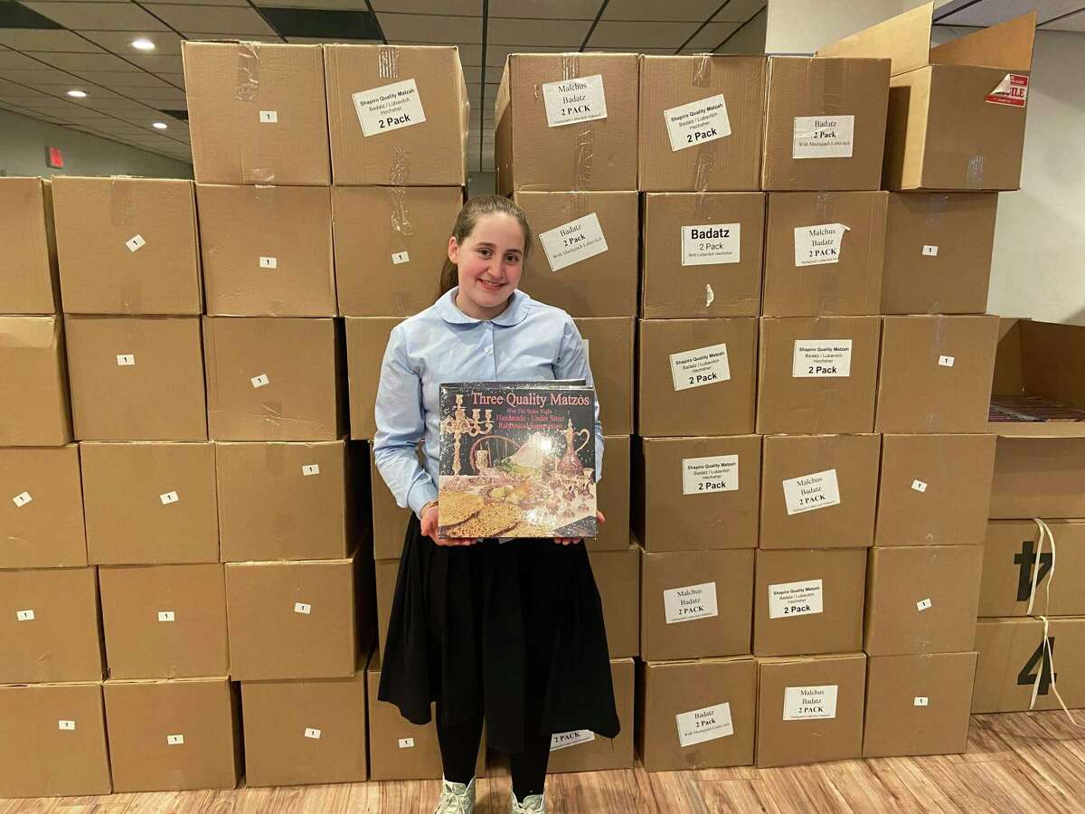 Hinda Landa holding a box of Shmura Matzah — one of 1200 that will be distributed to local families by Chabad of Fairfield.