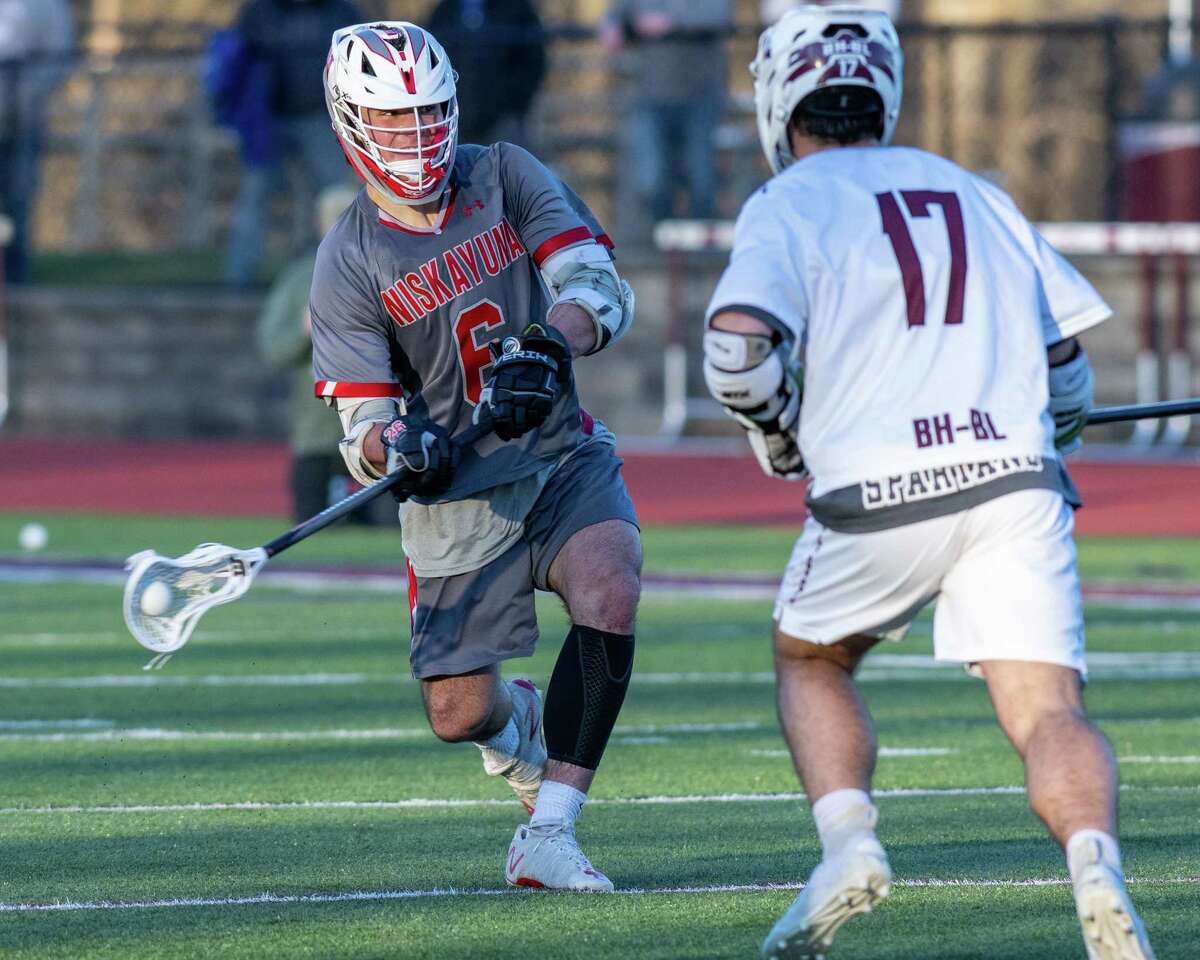 Niskayuna midfielder Lucas Klokiw takes a shot in front of Burnt Hills midfielder Jake Pausley during a Suburban Council matchup at Burnt Hills-Ballston Lake High School on Friday, April 8, 2022. (Jim Franco/Special to the Times Union)