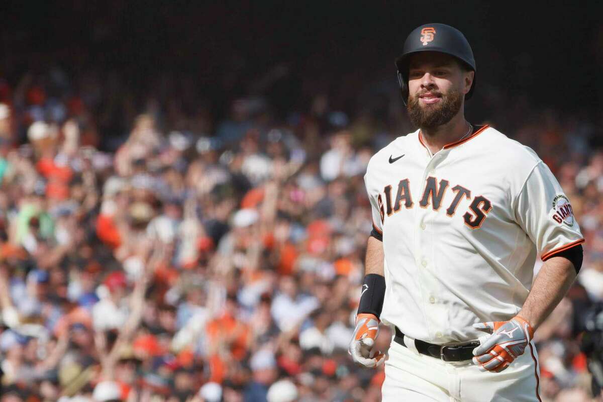 San Francisco Giants first baseman Brandon Belt (9) jogs to home plate after a home run in the eighth inning in an MLB game against the Miami Marlins, Friday, April 8, 2022, in San Francisco, Calif.