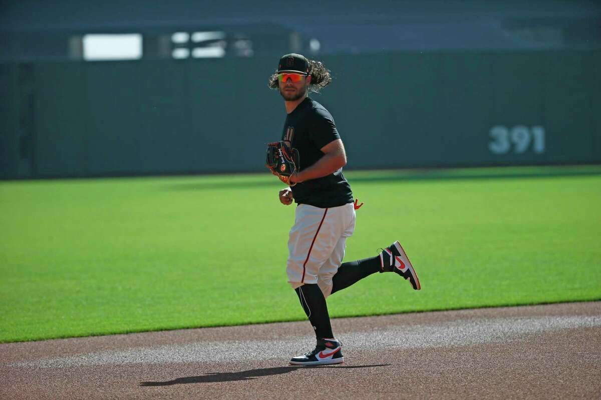 San Francisco Giants shortstop Brandon Crawford (35) takes the field to warm up ahead of their Opening Day baseball game against the Miami Marlins at Oracle Park, Friday, April 8, 2022, in San Francisco, Calif.