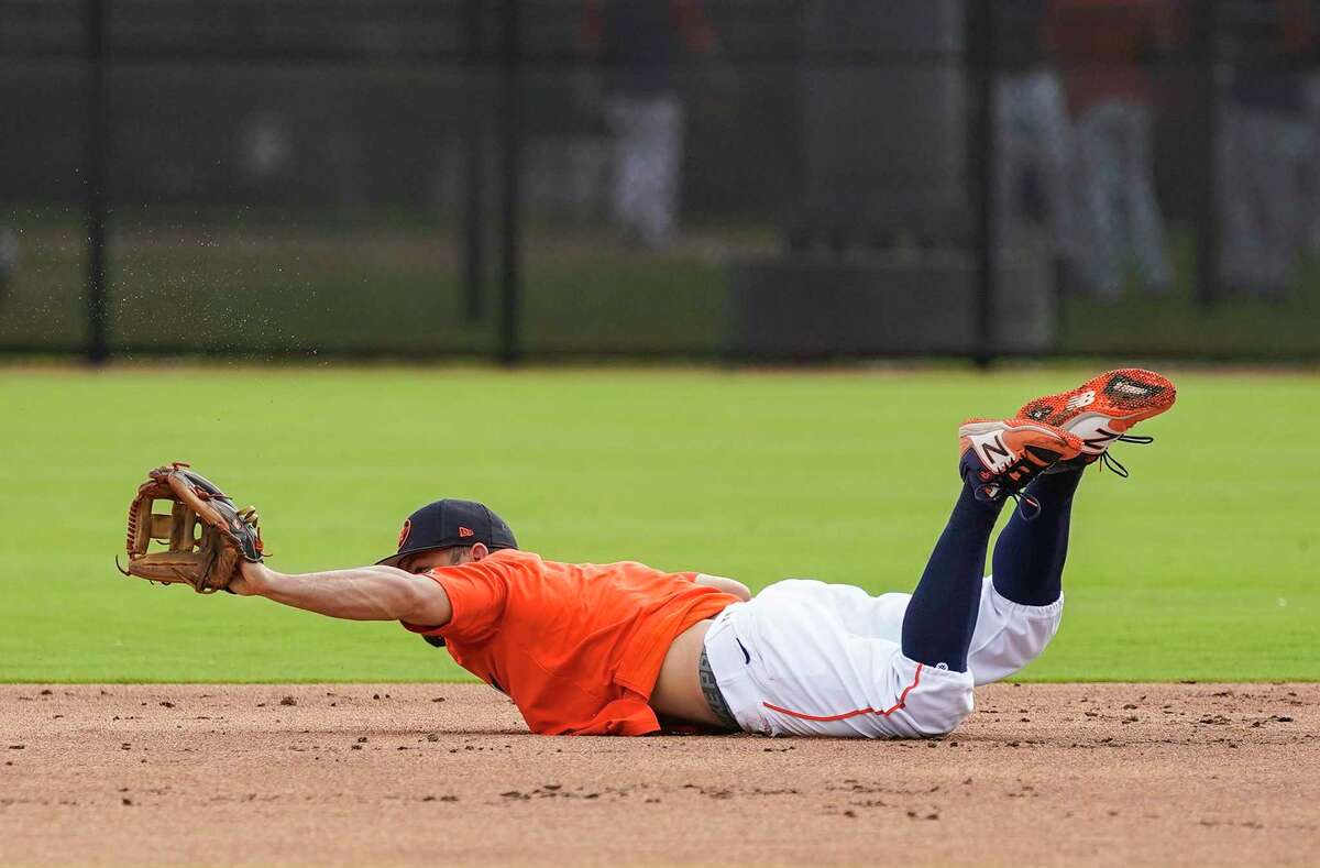 Jose Altuve, diving for a ground ball in spring training, would find himself on the infield dirt more if MLB adds rules to limit the shift.