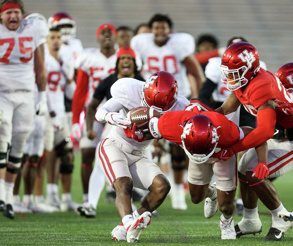 Houston Cougars defensive back Abdul-Lateef Audu (21) rips the ball away from wide receiver Matthew Golden (10) during spring practice at TDECU Stadium on Friday, April 8, 2022, in Houston.