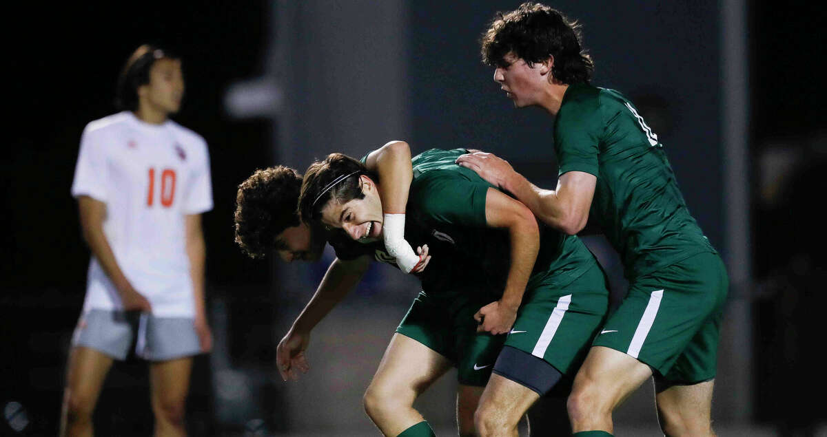 The Woodlands' Luis Quiros, center, celebrates with Jose Miranda, left, and Cody Tice after his first period goal gave the Highlanders a 1-0 advantage over Bridgeland during a Region II-6A quarterfinal high school playoff soccer match at Woodforest Bank Stadium, Friday, April 1, 2022, in Shenandoah.