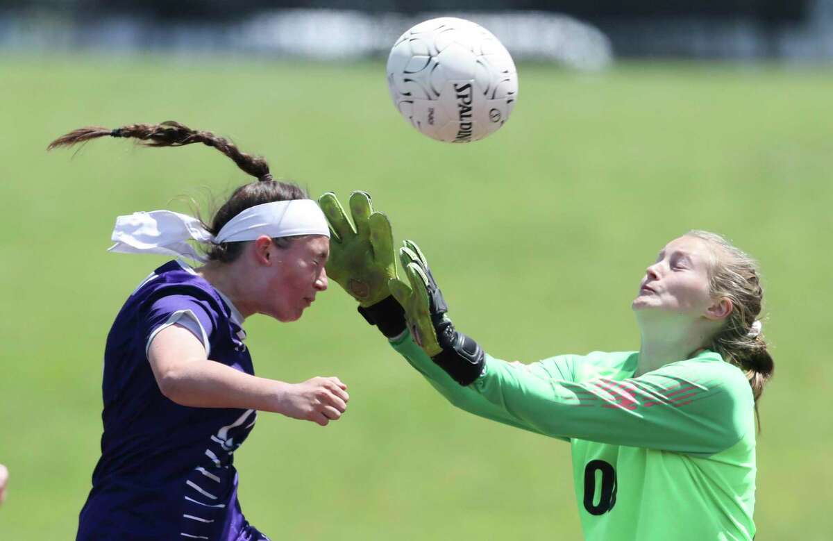 Ridge Point Panthers Laurel Kelley (17) heads the ball over Atascocita Eagles goal keeper Maggie Caldwell (00) head off of a corner kick in the first half in a Region III-6A semifinal girls playoff soccer game on April 8, 2022 at Abshire Stadium in Deer Park, TX.