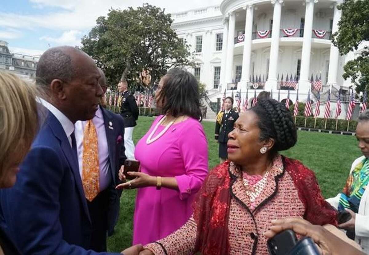 Mayor Sylvester Turner (left) shakes hands with U.S. Rep.  Sheila Jackson Lee (D-Houston) on the White House Lawn.