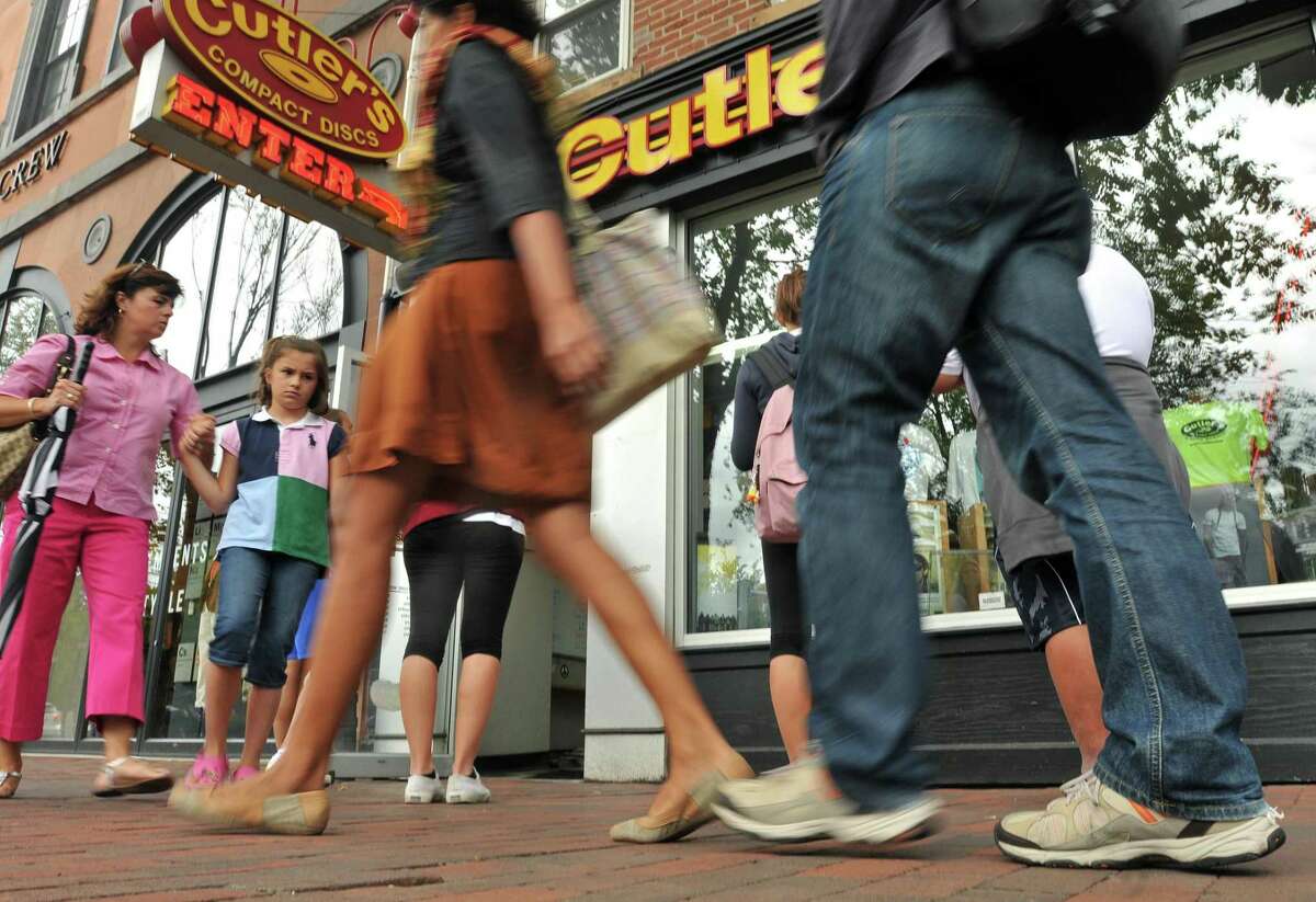 People walk by Cutlers Compact Discs on Broadway in New Haven in 2011. Clothing and footwear across Connecticut will be tax free starting Sunday.