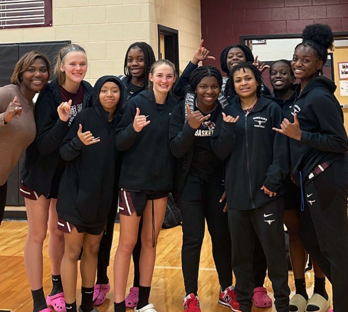 The George Ranch girls basketball team celebrates a District 20-6A victory that clinched a playoff spot. The Longhorns finished 19-12 including a third-place district finish.