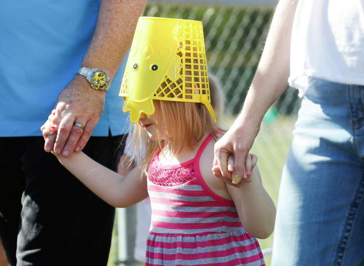Benhinn Kelly wears her Easter egg basked on her head during the annual Mr. Bunny Easter egg hunt at Carl Barton Jr. Park, Saturday, April 9, 2022, in Conroe.