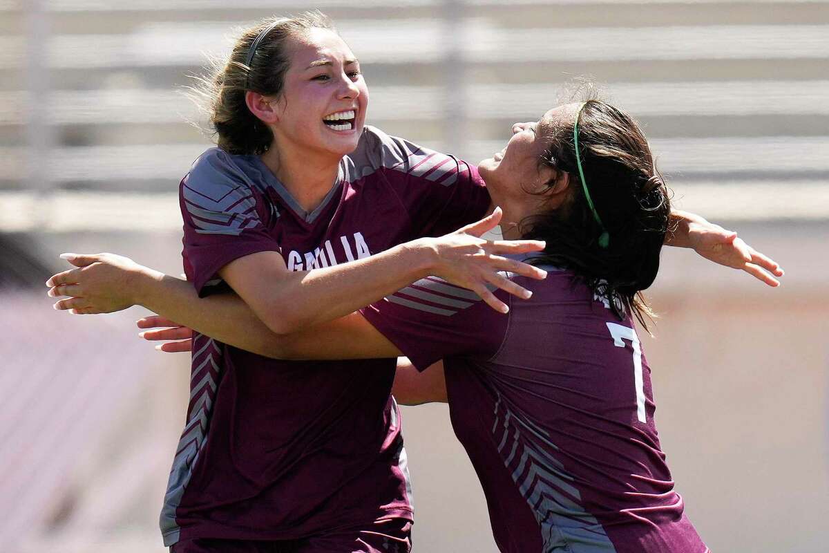Magnolia's Laney Gonzales, left, celebrates her goal with Gabriella Palomino during the first half of the Region III-5A final high school soccer playoff game against Friendswood, Saturday, April 9, 2022, in Humble, TX.