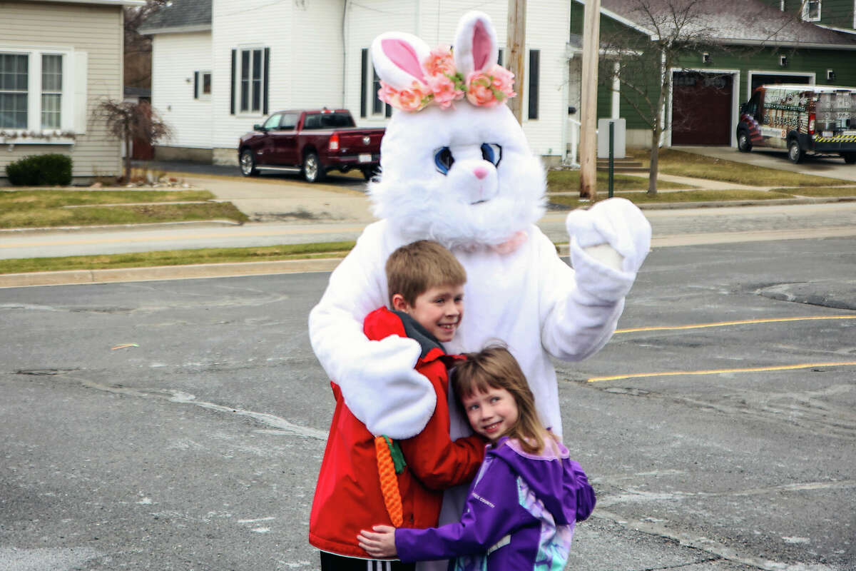 The Easter Bunny poses with children as their parents take pictures. Around 175 people showed up to the  Manistee County Library for a drive-thru celebration of spring with the Easter Bunny. Library staff also gave out books and other goodies.