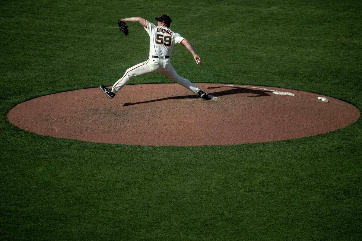 San Francisco Giants’ John Brebbia delivers a pitch during the tenth inning on Opening Day against the Miami Marlins in San Francisco, Calif. Friday, April 8, 2022. That Giants defeated the Marlins 6-5.
