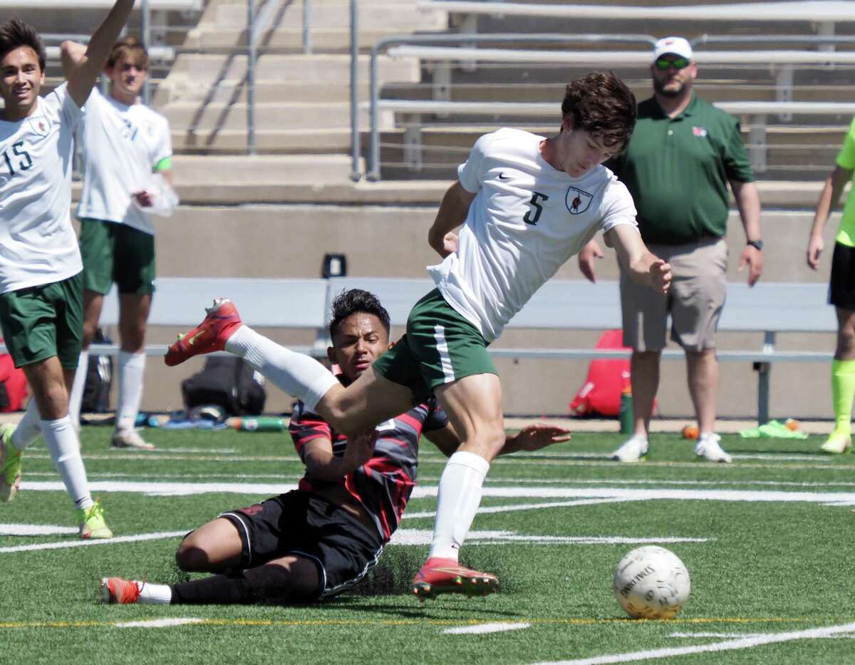 The Woodlands High School Highlanders Reinaldo Perera (5) avoids a tackle by MacArthur Generals Walter Aquiular (6) in the 2022 UIL Region II-6A regional soccer championship at the Kelly Reeves Athletics Complex on April 9, 2022 in Austin.