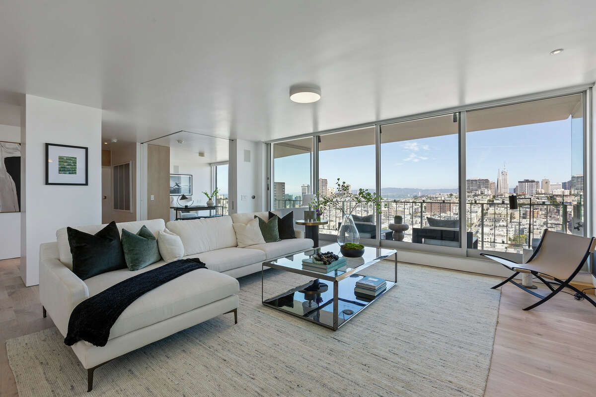 The wall of windows lets the skyline and water view become almost part of the interior.